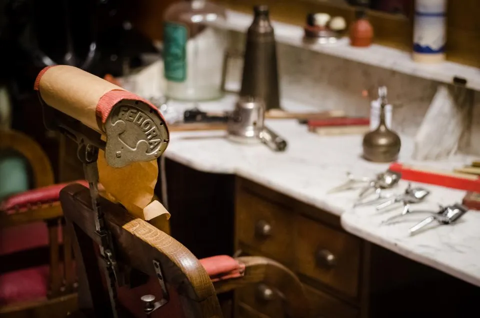 Fauteuil de barbier ancien devant un comptoir en marbre